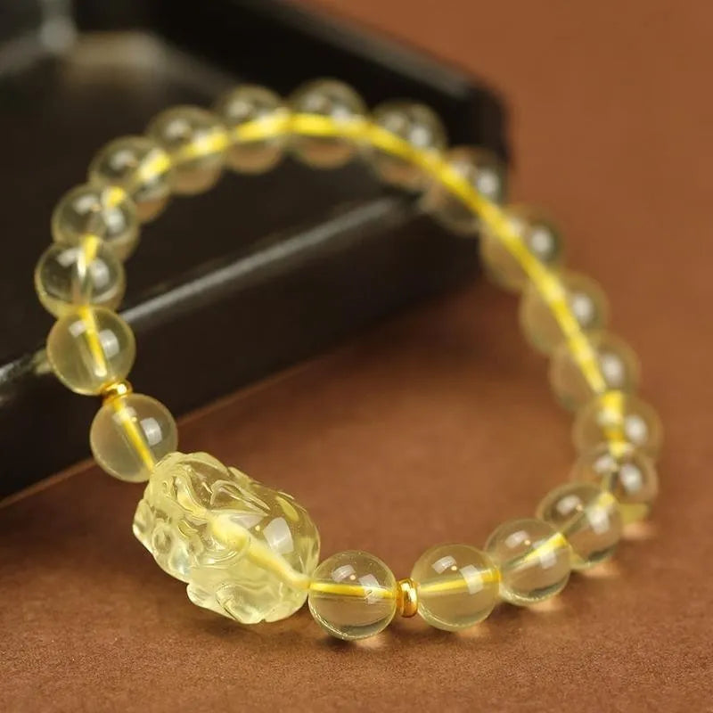 Yellow leather bracelet with a Pi Xiu charm and artificial crystal beads in national style.