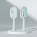 Blue pet grooming comb with integrated water tank and cleaning brush on a white background.