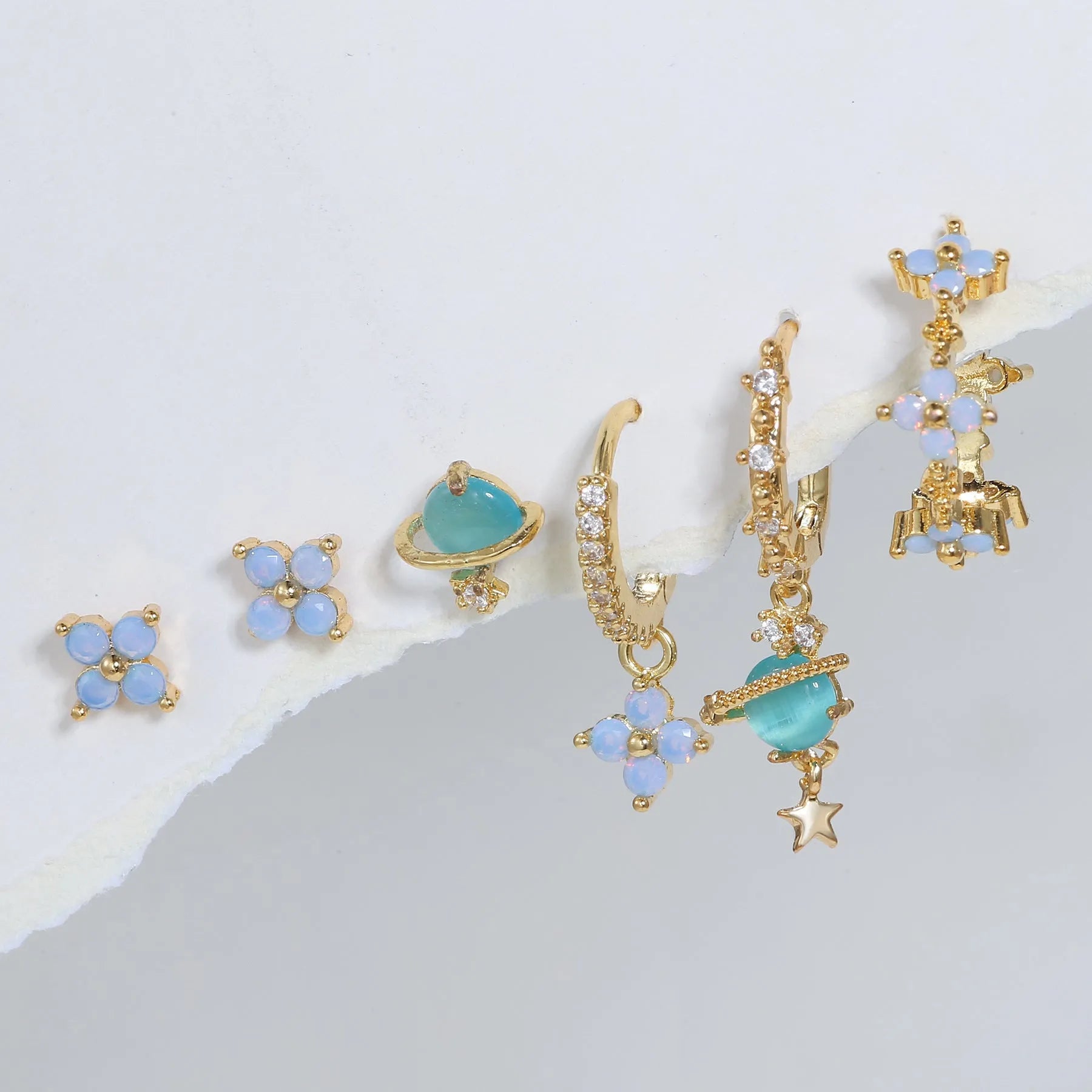 Gold and silver Japanese Korean style flower earrings studs with blue zircon mosaic detail.