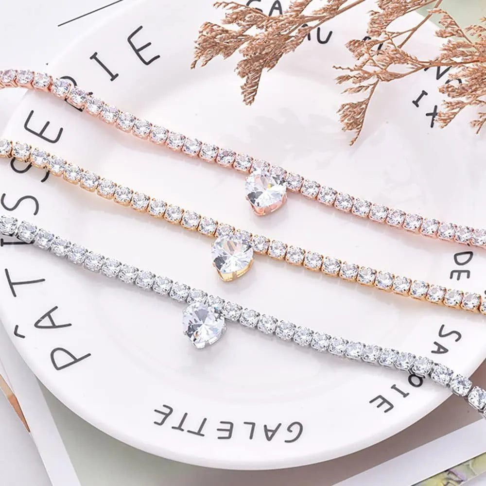 Gold heart-shaped rhinestone dog collar on a white background, showing adjustable chain.