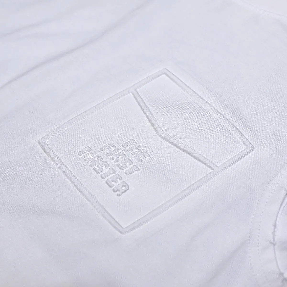 A white loose-fit cotton sleeveless t-shirt with a straight hem, laid flat.