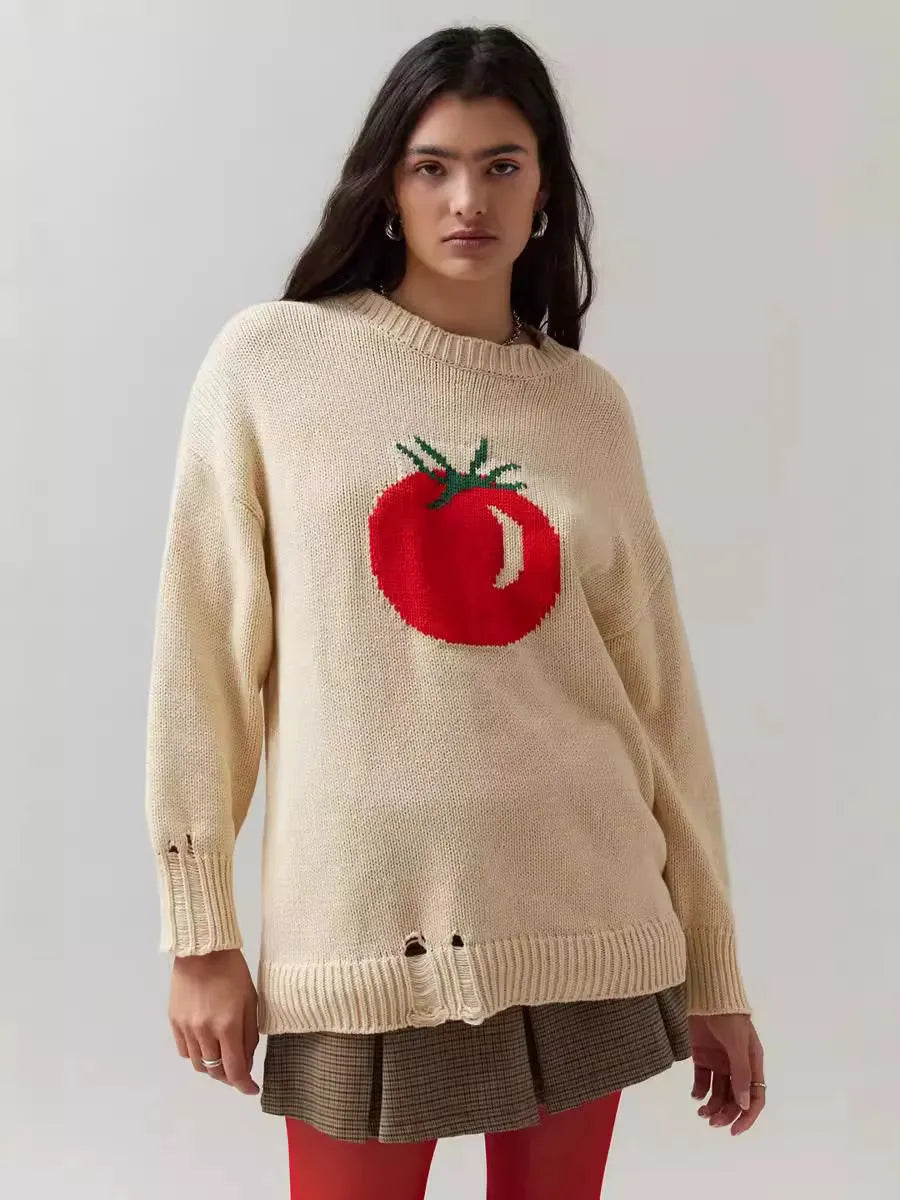 Women's loose-fitting beige jacquard knit sweater on a hanger, showing round neck and long sleeves.