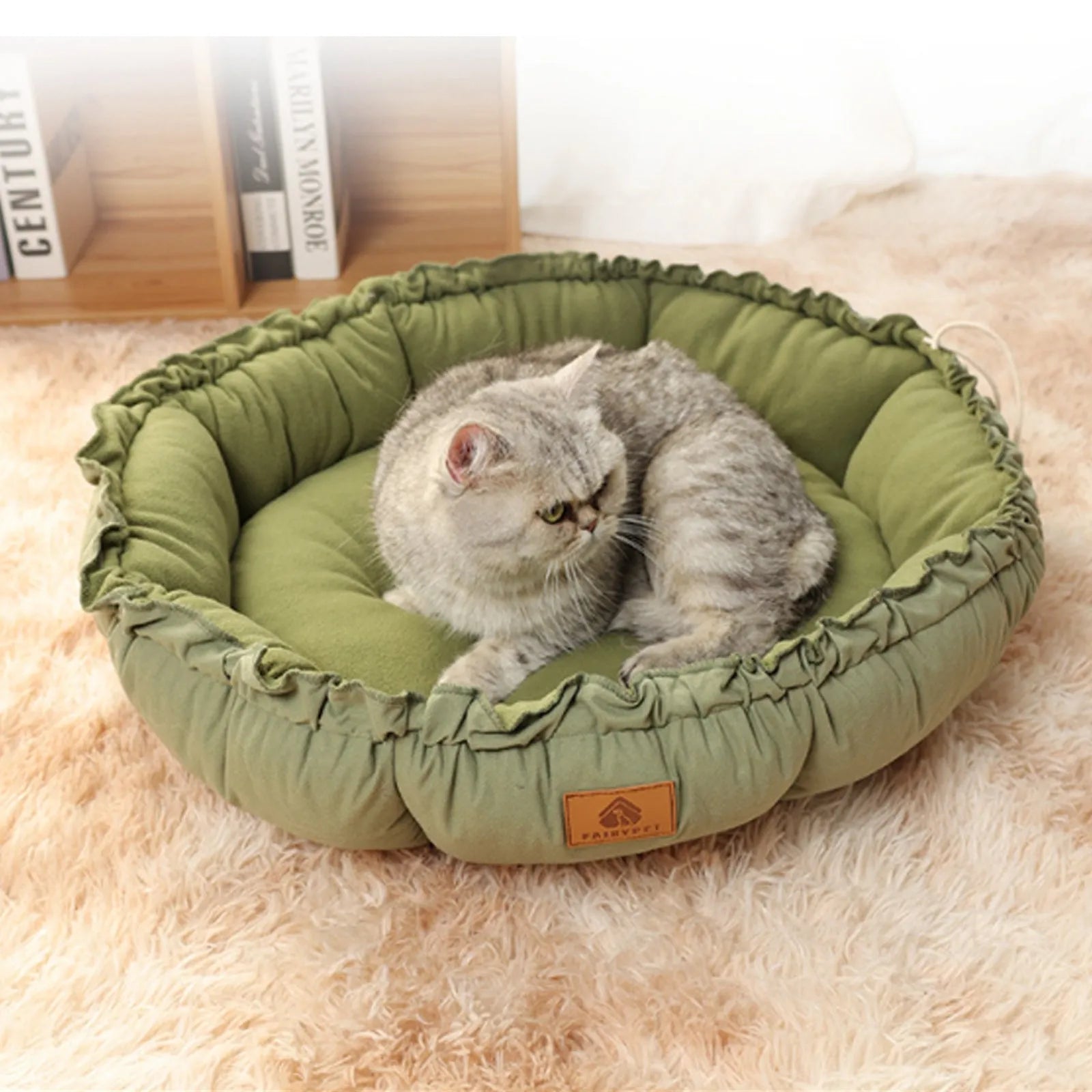Grey reversible donut cat bed showing both raised rim side and flat sleeping side