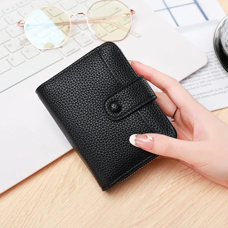 A beige ladies' short wallet with a textured lychee pattern, shown folded closed.