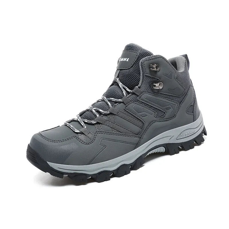 Flannel upper hiking sneakers with rubber soles in light brown colour on a rocky path.