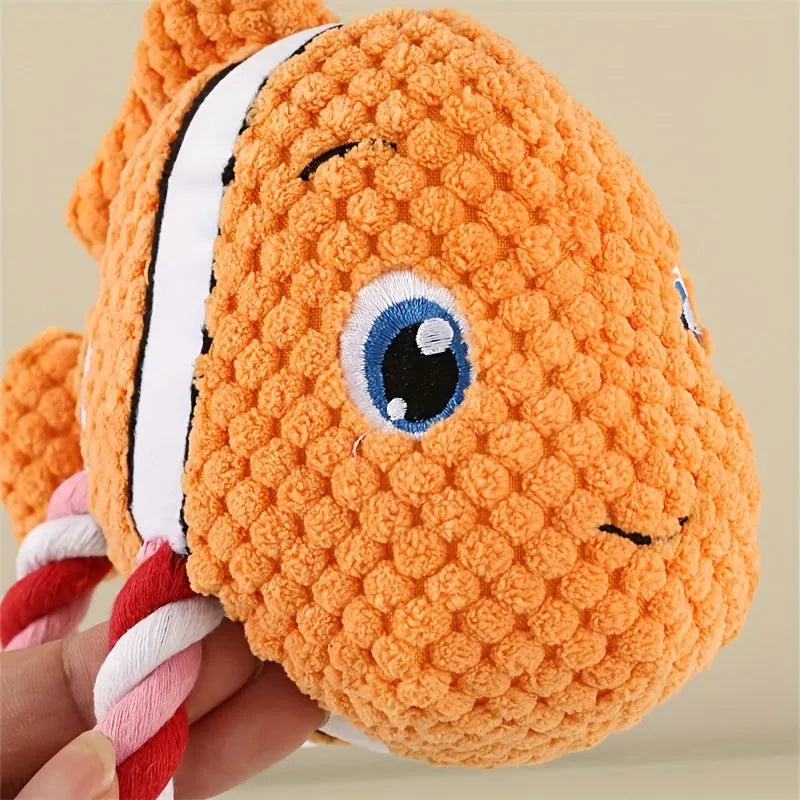 Grey, green, and orange turtle-shaped soft plush dog chew toy with internal knots.