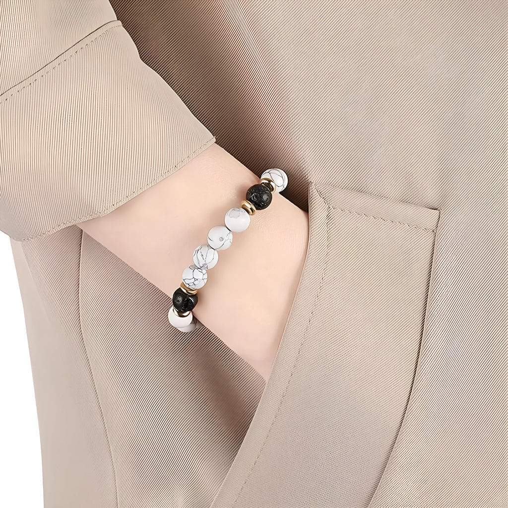 Natural stone bracelet with alloy volcano white turquoise centrepiece and mixed tiger eye beads on white background