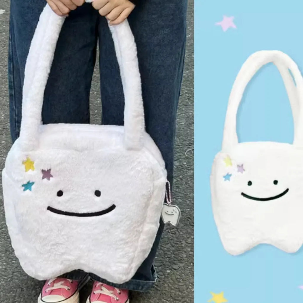 White plush large tooth design shoulder tote bag with a zipper, shown as a unisex crossbody bag.