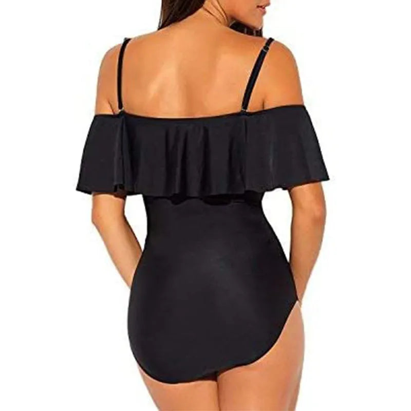 Black strapless one-piece swimsuit with side cut-out details and ruffled shoulder straps.
