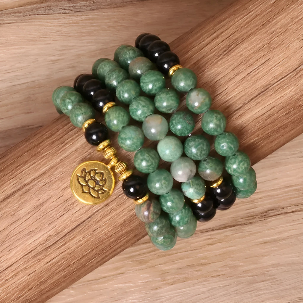 Green and black alloy bead elastic long bracelet on wrist.