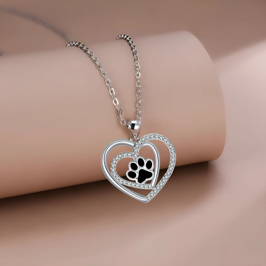 Copper heart pendant necklace with dog paw print detail on a cross chain.