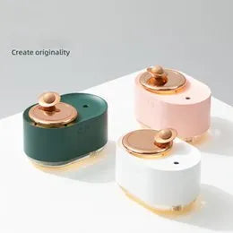 Green rotating planet-shaped USB humidifier with night light on wooden surface