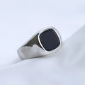 Men's titanium steel hexagonal ring with glossy black epoxy inlay and polished finish on white background