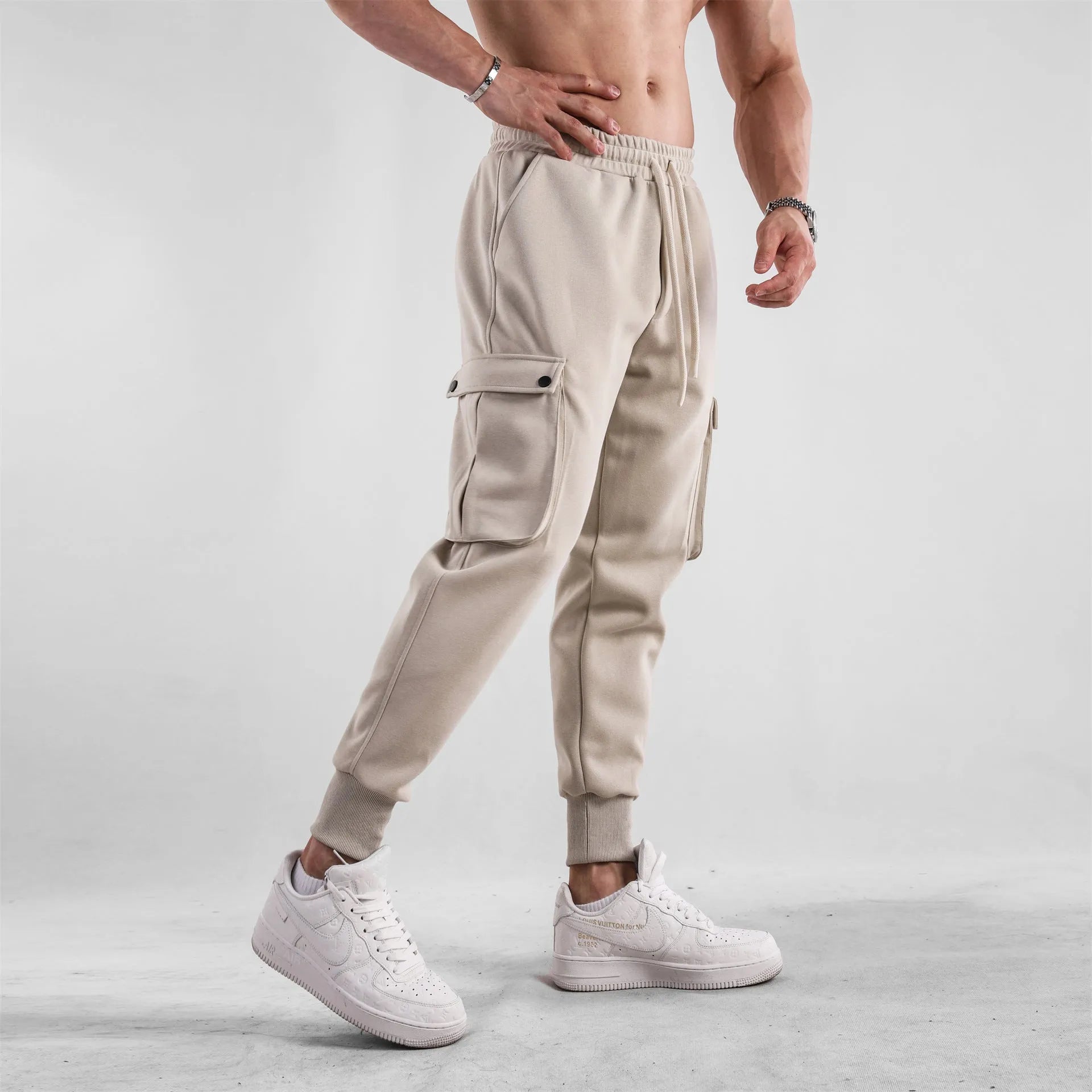 Men's loose cotton sports trousers with ankle tie detail and multiple pockets in apricot colour