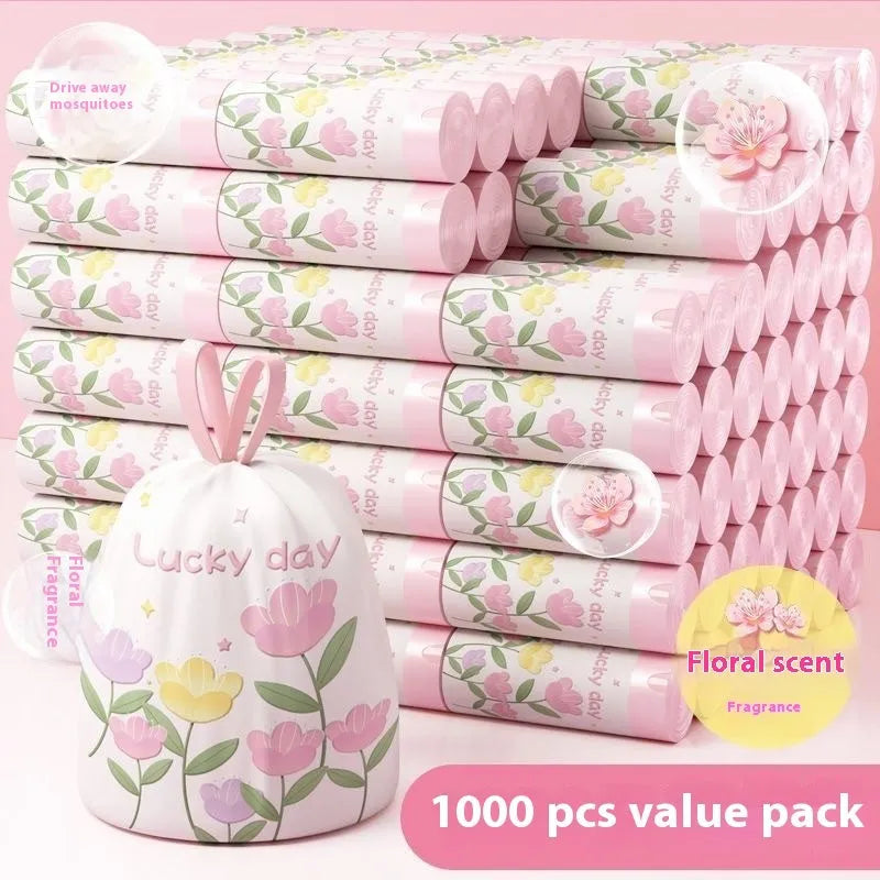 Pile of bold pink degradable drawstring garbage bags with argy wormwood for mosquito repellency.