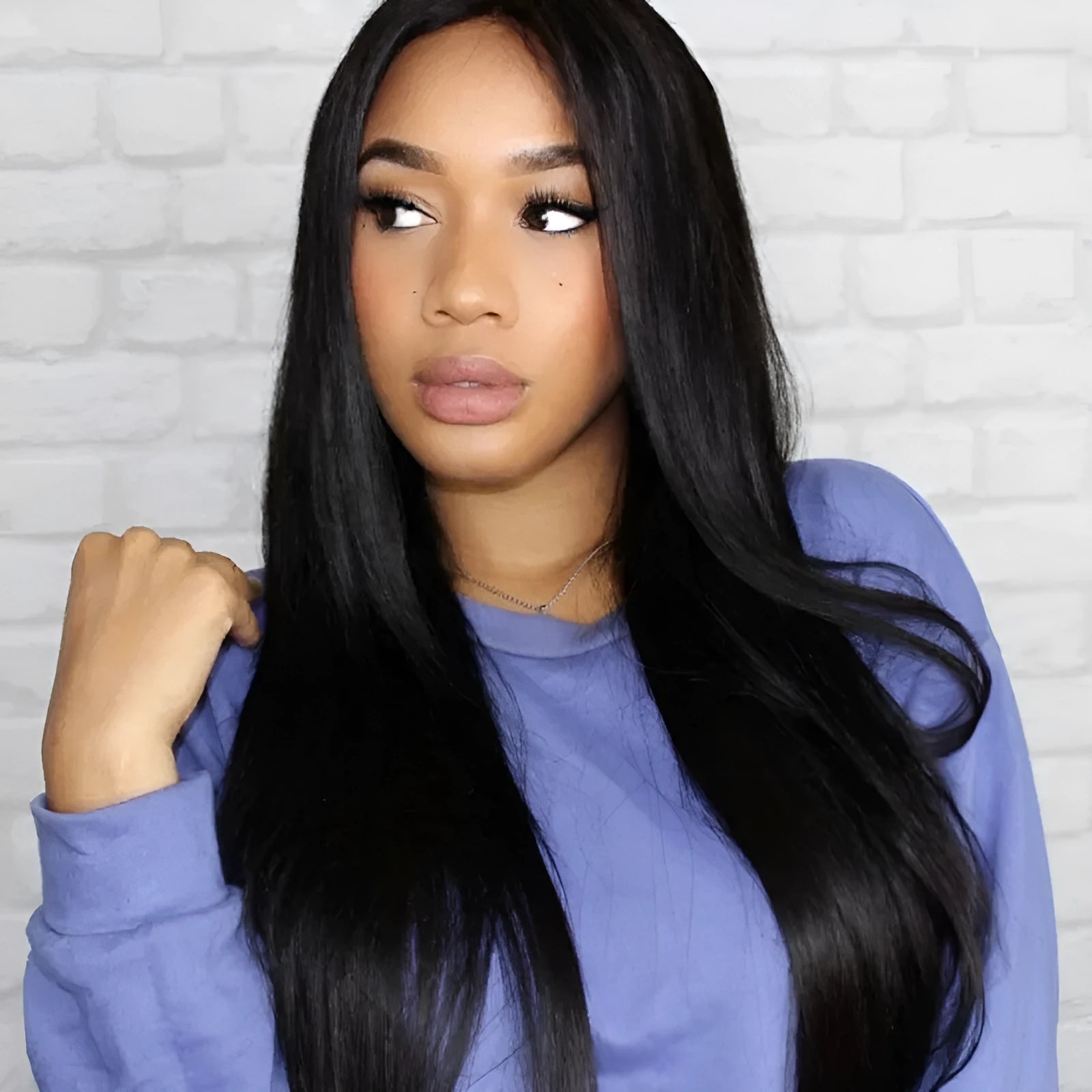 Long straight black synthetic wig with centre-parted bangs on mannequin head