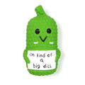 Bright green pickle-shaped latex dog chew toy with textured surface and squeaker inside