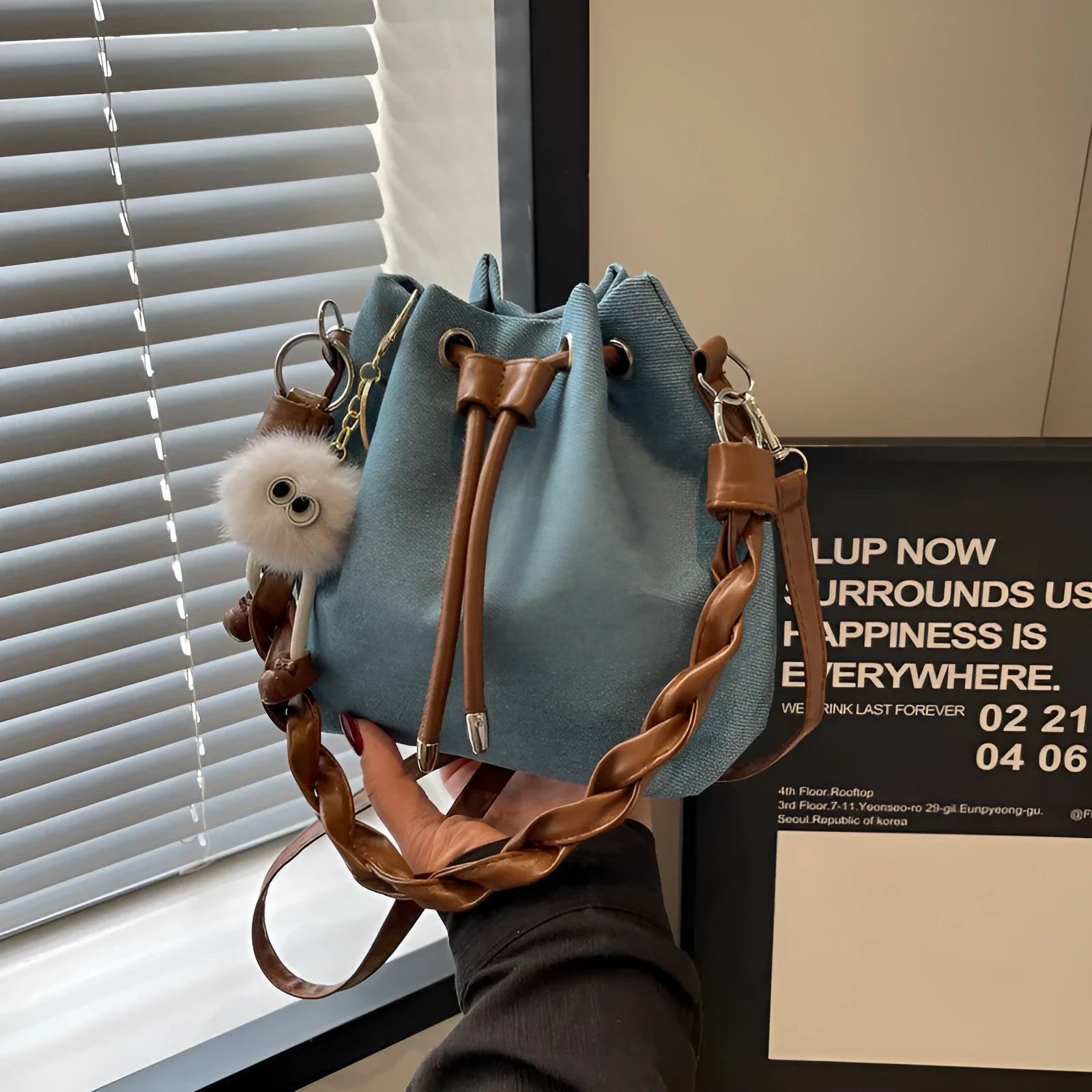 One-shoulder cross body bucket bag in blue colour with synthetic leather lining