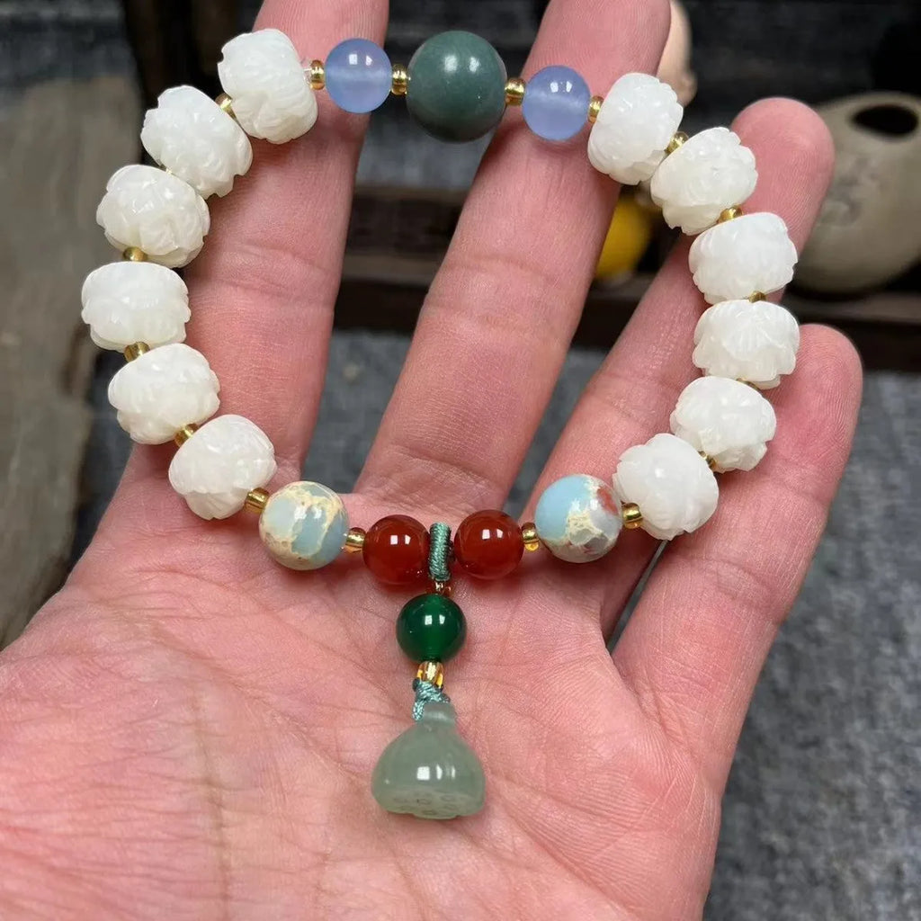 Hand-carved bodhi root bracelet with pumpkin lotus beads, white jade accents, and cat claw pendant
