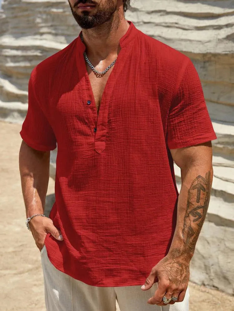 Men's solid colour stand collar short-sleeved shirt in a light blue shade on a hanger.