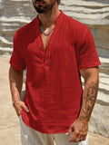 Men's solid colour stand collar short-sleeved shirt in a light blue shade on a hanger.