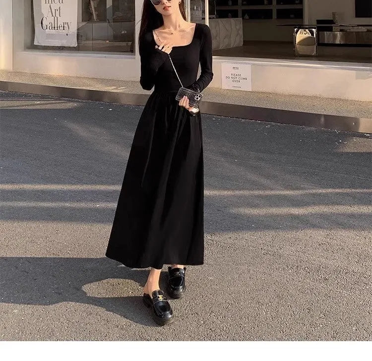 Black knitted square collar dress with long sleeves and an A-line long skirt on a model.
