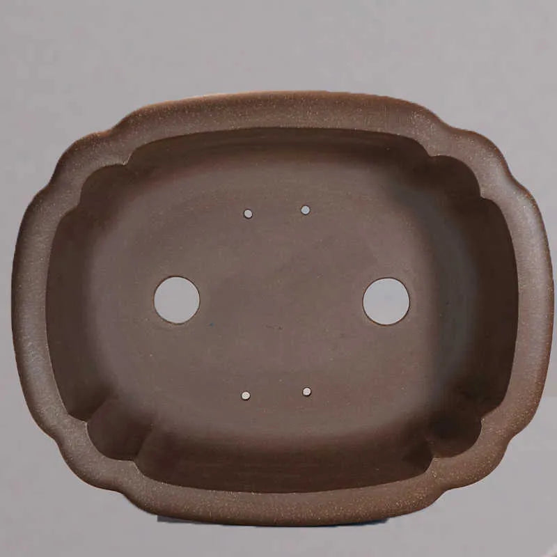Purple sand handmade rectangular begonia flower pot on a tabletop.