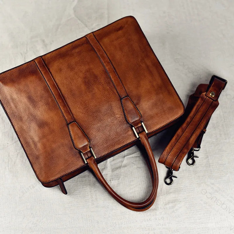 Men's brown leather retro handbag with horizontal square shape and zipper opening.