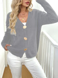 A grey women's deer plush long sleeve sweater coat with Princess sleeves on a hanger.
