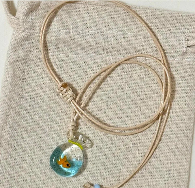 Women's pendant necklace with coloured glaze joker charm on cotton linen chain