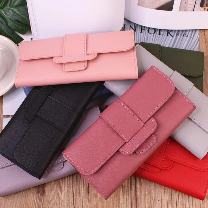 Women's long tri-fold wallet in light grey PU leather with sewing thread detail, open to show multiple card slots and cash compartments.