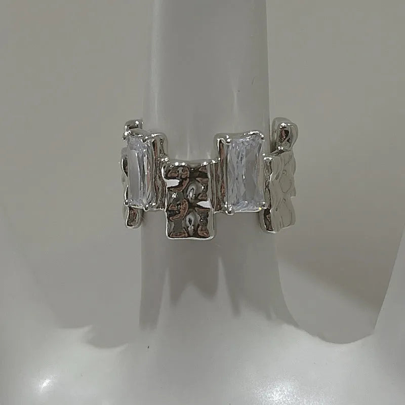 Silver geometric cross ring with open zircon stone setting and retro design