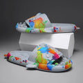 Pair of grey shark-shaped open-toe EVA home slippers on a white background.