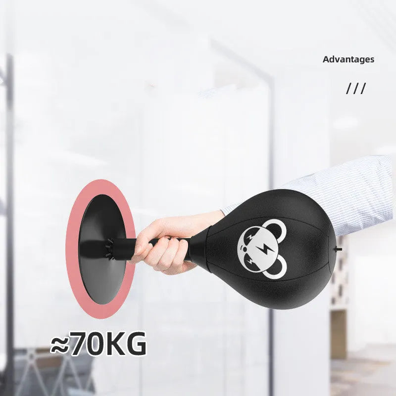Tabletop boxing speed ball with black PU leather inflatable ball on desk using suction cup base for reflex training and stress relief.