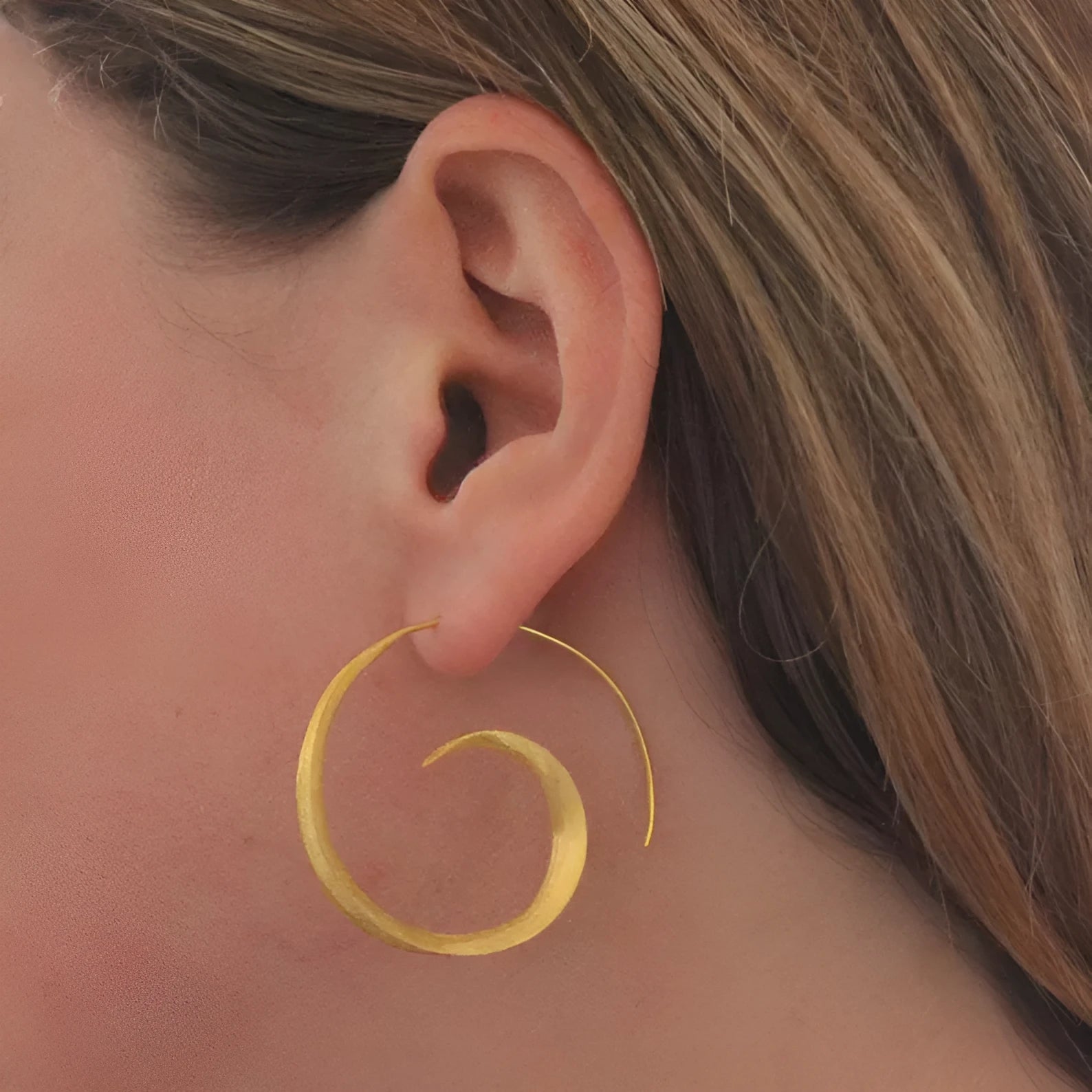 Round alloy ear studs with spiral leaf design in gold electroplated finish on white background