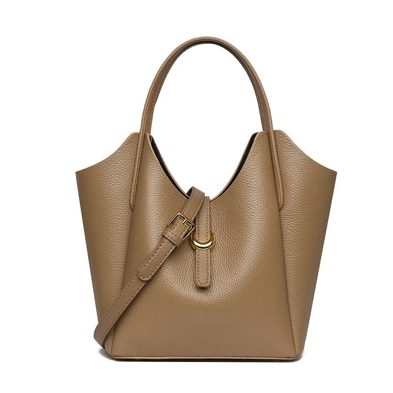 Genuine leather women's hand holding bucket bag in European American retro style with visible sewing thread detailing