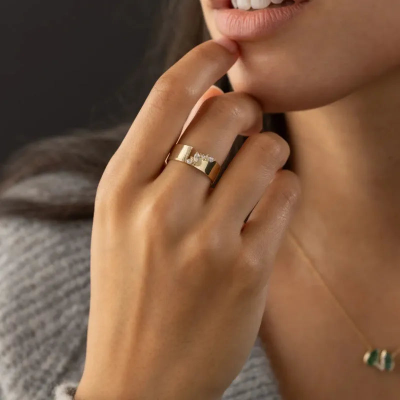 Gold electroplated women's ring with a central zircon stone, shown in size options 6 to 10.