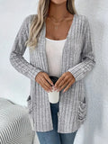 Solid colour long sleeve cardigan with front pockets, loose fit polyester knitwear