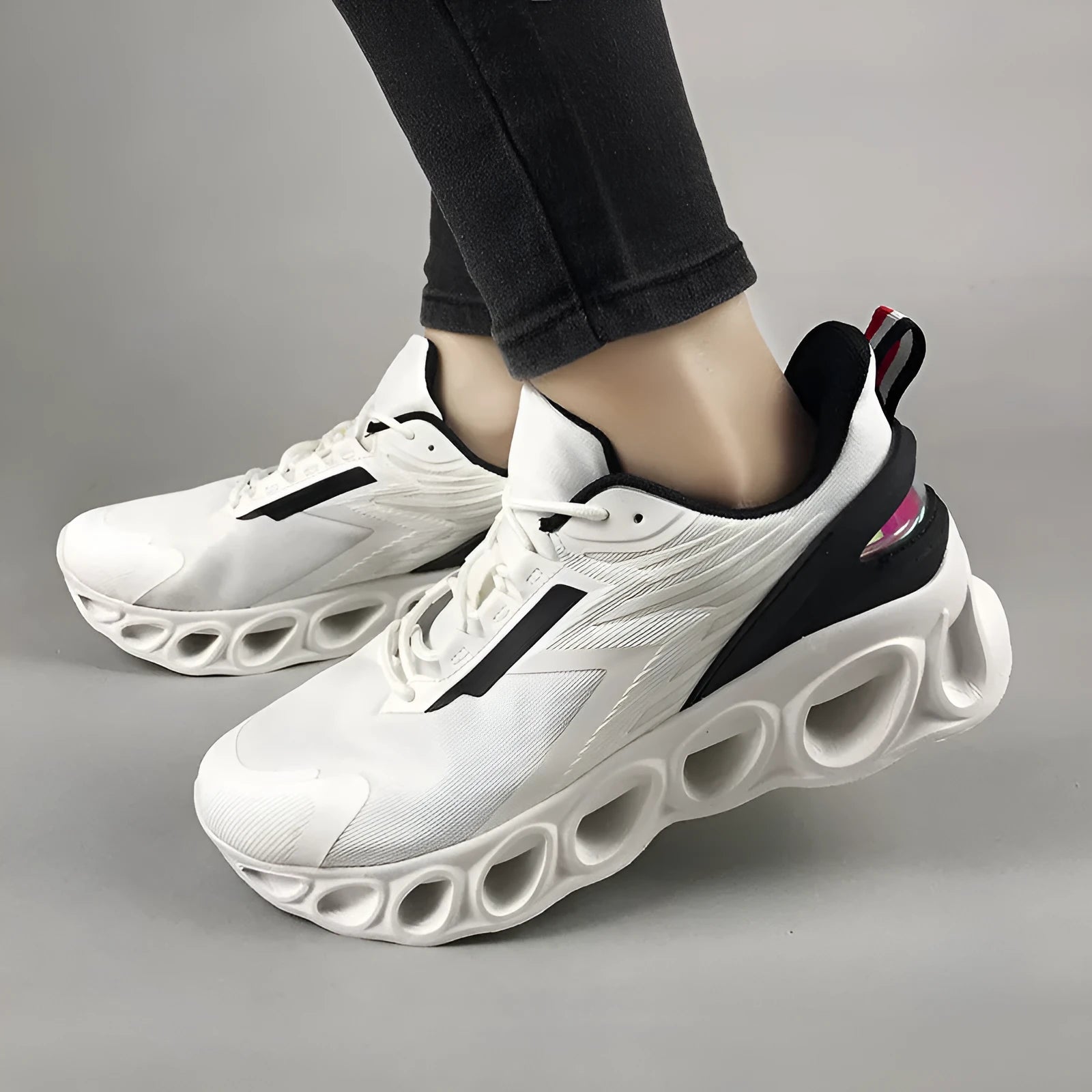 Men's low-top black mesh sports sneakers with white sole and lace-up closure on a white background