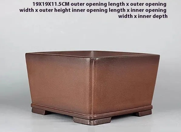 Handmade brown antique purple clay flower pot for desktop plants.