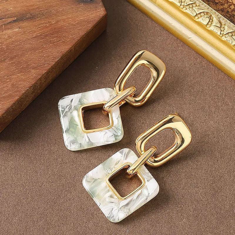 Copper hollow geometric square earrings with electroplated finish, chamfered corners, and two colour options