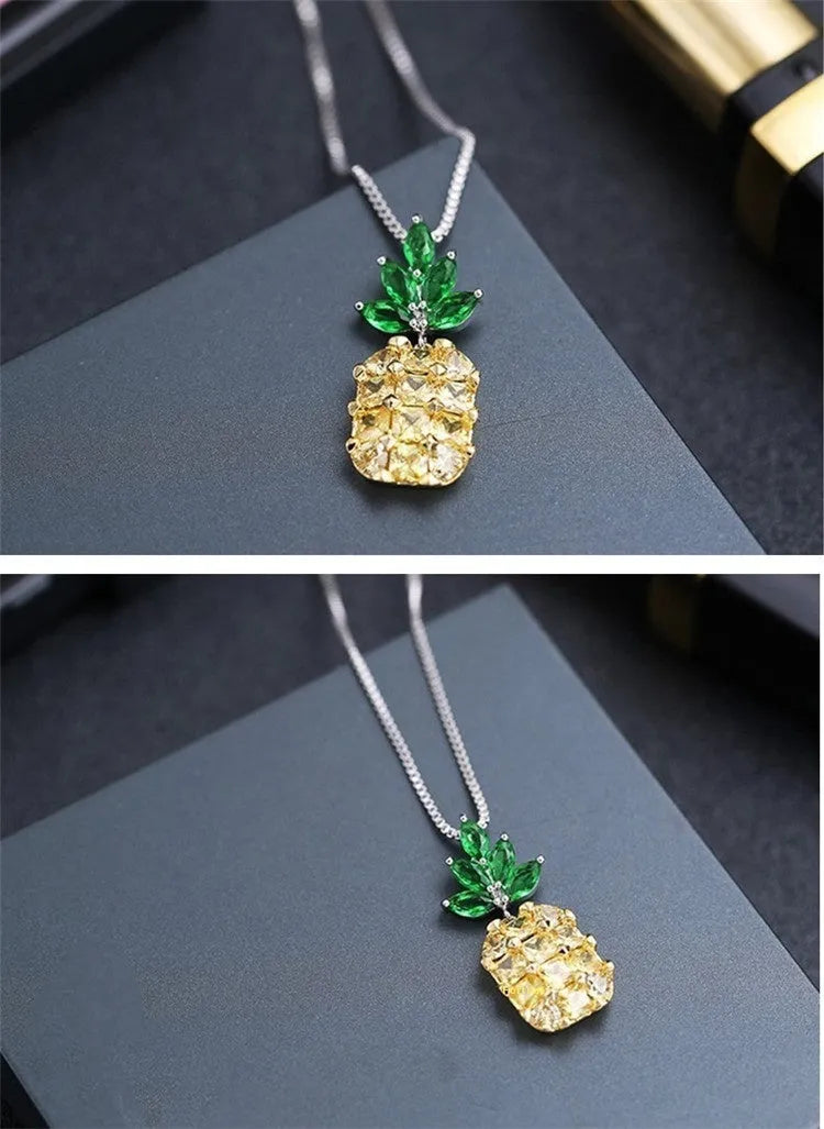 Silver women's necklace with a geometric pineapple and diamond design pendant on a chain.