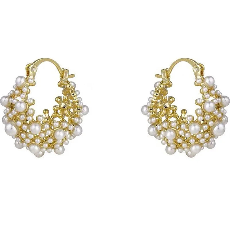 Gold-coloured copper flower basket earrings with white pearl inlay and small rice-shaped bead details.