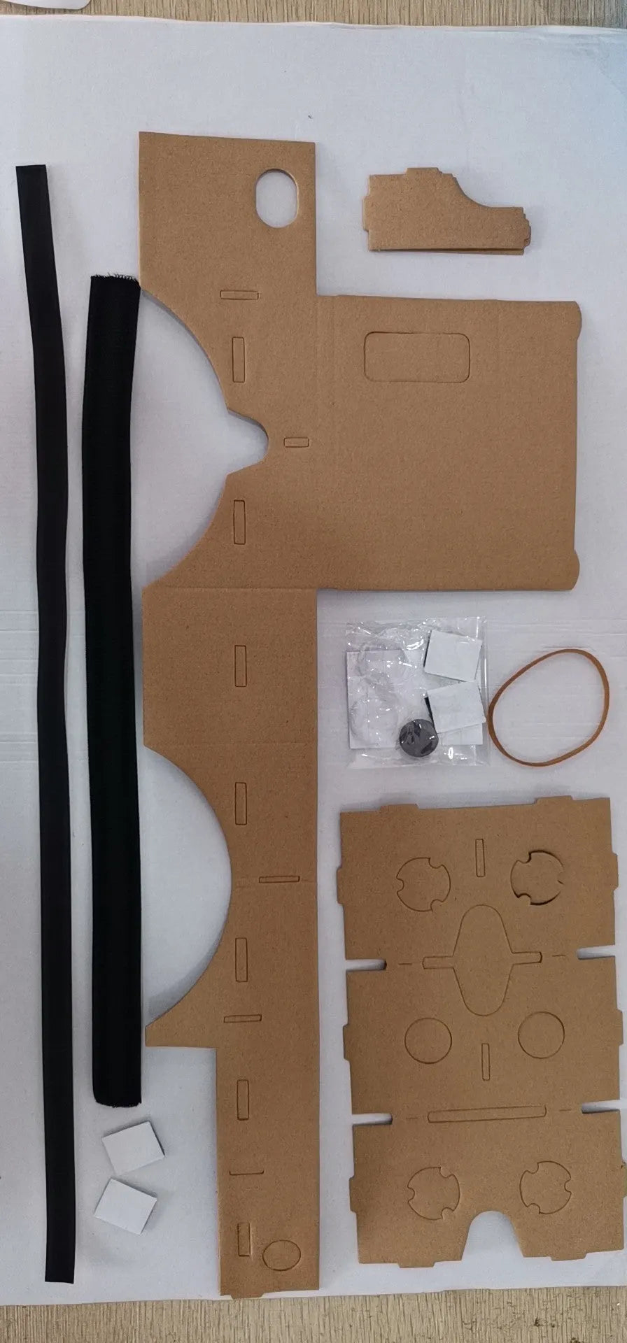 Pink and white cardboard VR glasses viewer for smartphones with 3D lenses.