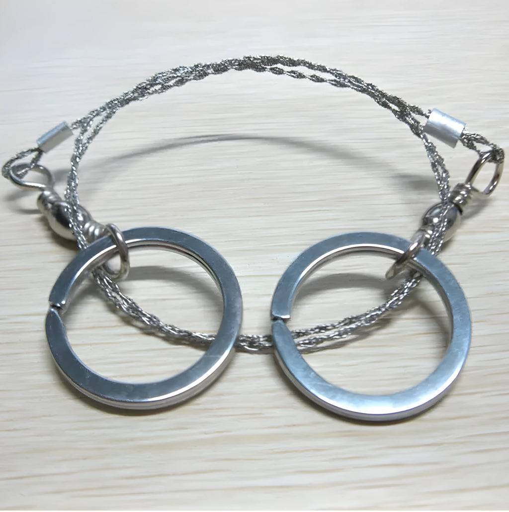 Survival wire saw tool with stainless steel blade and pull rings for outdoor cutting