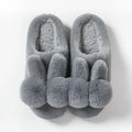 Women's bunny fluffy slippers in rabbit fur, shown in cream colour with floral detail and a sewn sole.