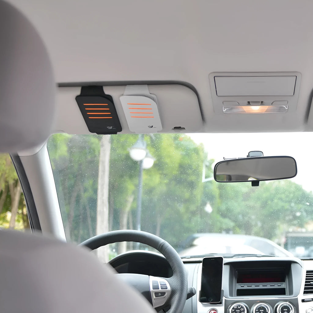 Set of four grey car sun visor panels next to a fabric storage pouch on a car dashboard.
