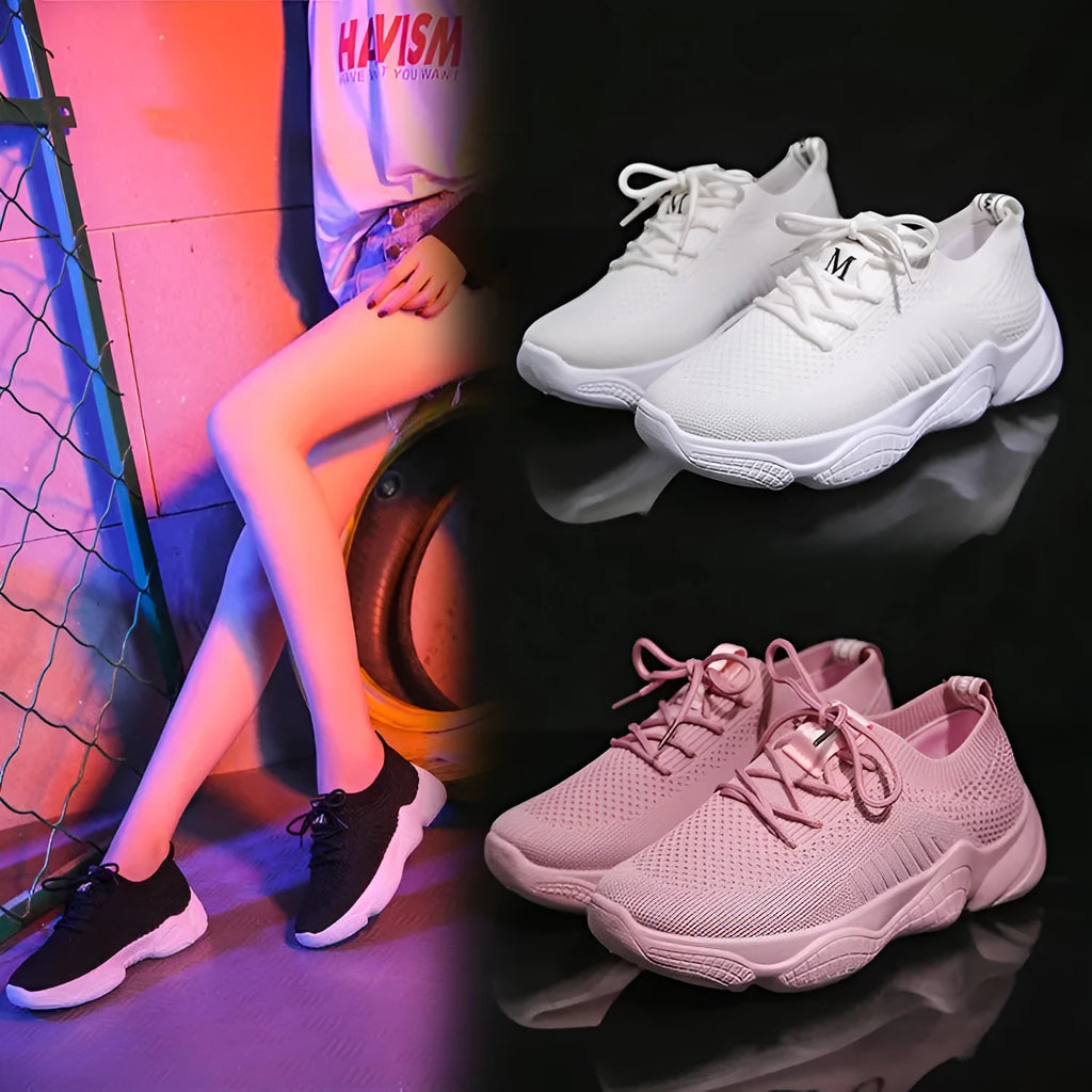 Women's white thick-soled woven trainers with front strap fastening on a plain background.