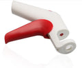Cherry kernel remover, a handheld plastic kitchen gadget for pitting cherries, on a light background