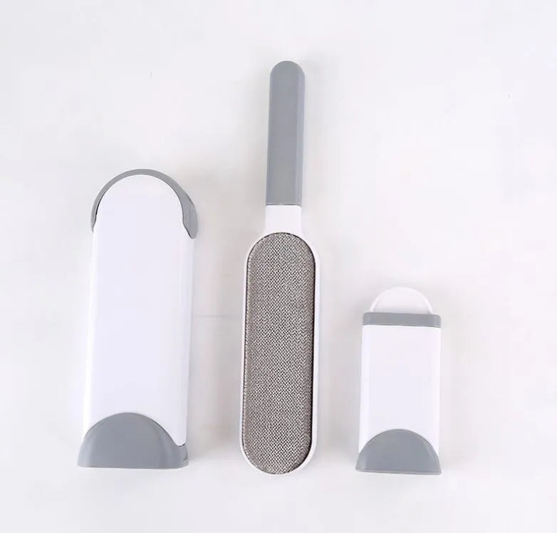 Blue self-cleaning pet hair removal brush for sofas on a grey fabric couch.